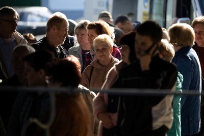 Residents flee Ukraine's Kherson after Russian strikes and warnings
