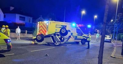 Man taken to hospital after car flips onto roof during crash in Belfast