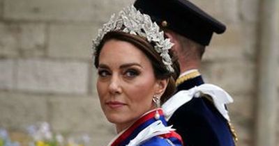 Dazzling Kate Middleton ditches tiara and has to hitch up Coronation dress due to rain