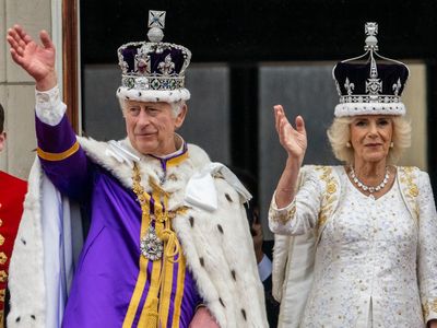 King and Queen watch scaled-down flypast from palace balcony