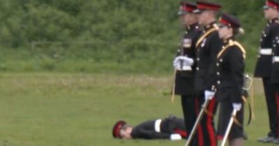 Moment soldier faints during Coronation gun salute before being dragged through mud