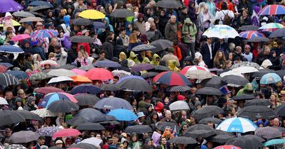 Fights break out over UMBRELLAS in crowds as royal fans get soaked waiting for King