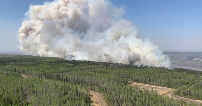 Thousands flee as 100 wildfires tear through western Canada with emergency declared