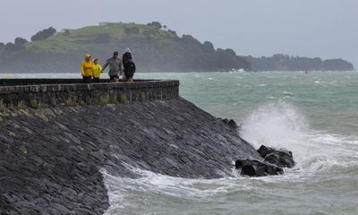 New Zealand: child missing in cave as country hit by heavy rain and flooding