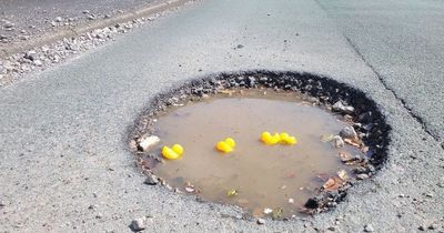 Large pothole turned into rubber duck 'pond' by angry locals in 'nightmare' road