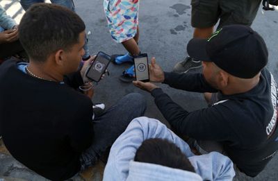 'A game of chance': Migrants battle glitchy app at US border