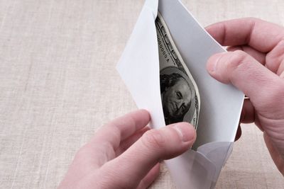 Why people are making TikToks of themselves stuffing cash into envelopes, like Granny used to do