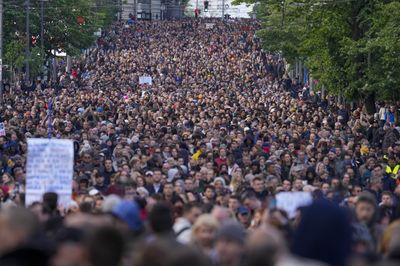 Tens of thousands march against Serbia's populist leadership following mass shootings