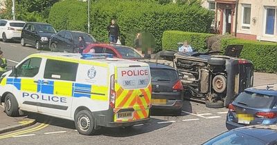 Edinburgh police race to car crash as vehicle overturns at busy junction