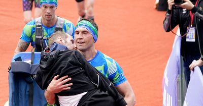 Watch the moment Kevin Sinfield carries Rob Burrow over the finishing line to complete Leeds Marathon