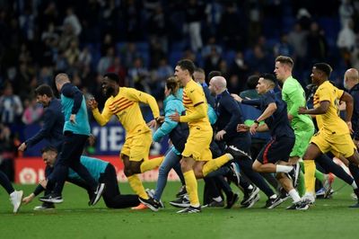 Triumphant Barca players chased from pitch by angry Espanyol fans