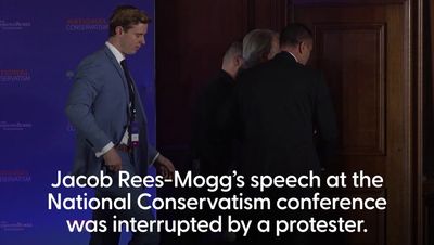 Watch: Protester storms stage during Jacob Rees-Mogg speech at National Conservatism conference