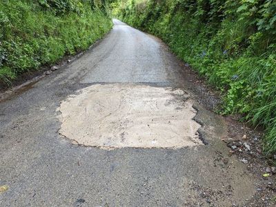 Mystery motorist hunted after filling huge pothole with concrete