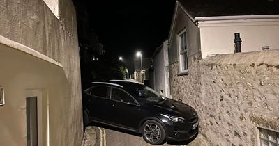 Driver gets car stuck between two homes and blocks street sparking fury from locals