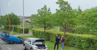 Two men rushed to hospital after car flips onto roof in Edinburgh crash