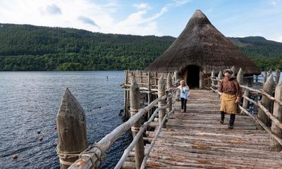 Iron age roundhouse rises from the ashes on shores of Scottish loch