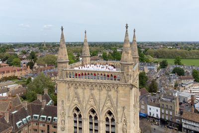 Choir climbs 163ft tower and sings from rooftop in Cambridge college tradition