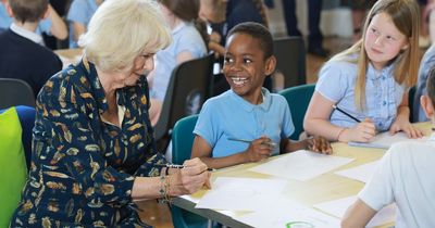 Queen Camilla draws her own crown and isn't covered with mud at Bristol school visit