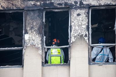 New Zealand police lower hostel fire death toll to 5; man held in jail on arson charges