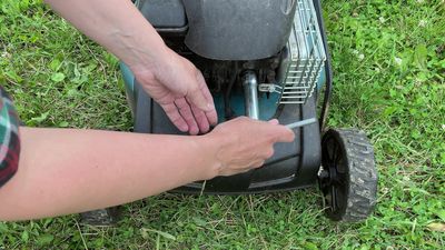 Where is the spark plug on a lawn mower?