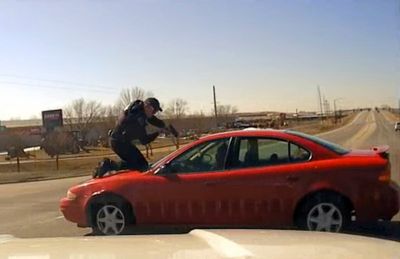 Video shows driver fleeing Iowa police with officer on hood, roof of car