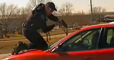 Terrifying footage shows cop clinging to ROOF of speeding car as callous criminal flees
