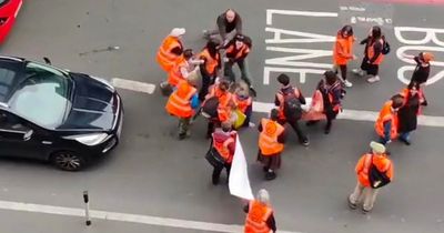 Shocking moment furious man shoves Just Oil protestor as march grinds traffic to a halt