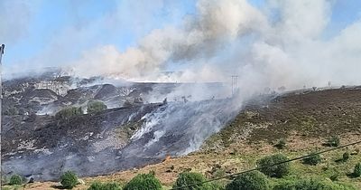 Major fire tears across mountain close to people's homes