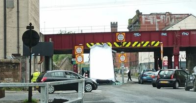 Three rushed to hospital after Glasgow bus crashes into railway bridge