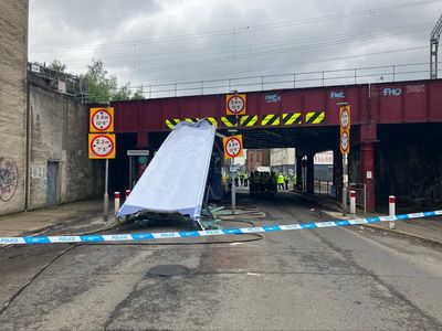 Ten people in hospital after roof ripped off bus in rail bridge crash