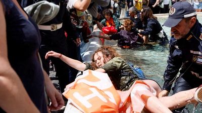 Climate activists in Rome turn Trevi fountain's water black in protest against fossil fuel subsidies