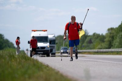 Unable to fight now, two Ukrainian amputees walk to raise funds for a military hospital