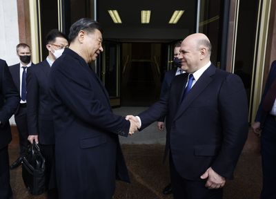 Russian PM arrives in China for business forum, talks with Xi