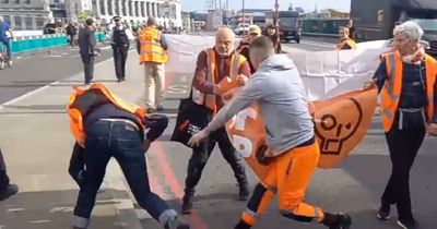 The moment man is tackled by police after throwing climate protester to the ground