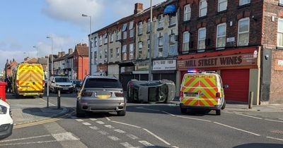 Woman taken to hospital after Fiat flips onto its side