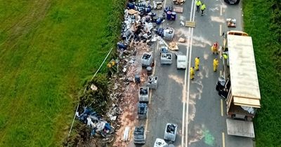 Massive clean-up underway after battery acid and oil spills from overturned lorry on busy Louth road