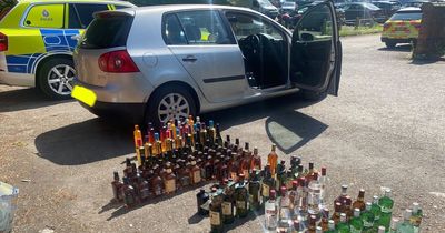 Socks, tortilla wraps and DOZENS of bottles of booze: The bizarre haul recovered from 'shoplifters' on major road