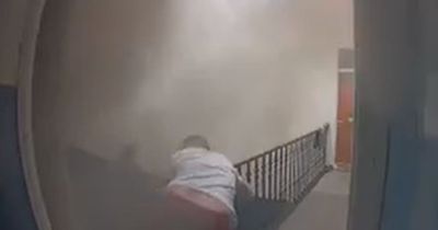 Dramatic footage shows hero neighbours kick down door to save man from Edinburgh flat fire