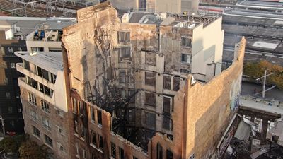 Two teenagers hand themselves in to police after massive fire tears through inner-city Sydney building