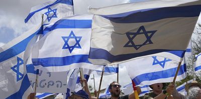 Anti-government protesters are reclaiming the Israeli flag from the far-right