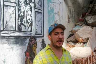Yemen street artist chronicles war on battle-scarred walls