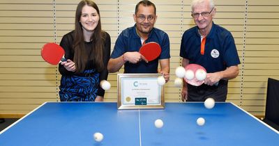 Table tennis volunteer takes game point with award