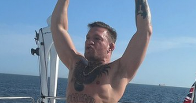 Conor McGregor poses in speedos as he lifts weights on his private yacht