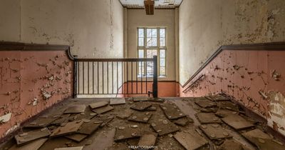 Inside the abandoned school left to rot with old textbooks strewn on floor and 'Nerd' graffiti