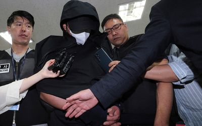 South Korean man arrested for opening plane’s emergency door