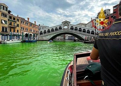 Venice's waters turn fluorescent green near Rialto Bridge
