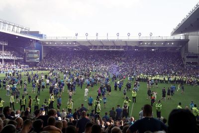 Everton fans storm pitch after beating relegation before chants to ‘sack the board’