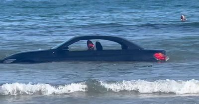 'You can’t park there!' - BMW washed out to sea after parking on West Country beach