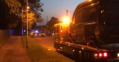 Police tape off street outside Greater Manchester park after crash involving motorbike and Amazon van