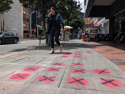 The spray-can vigilantes shaming Bogotá for its perilous paving slabs